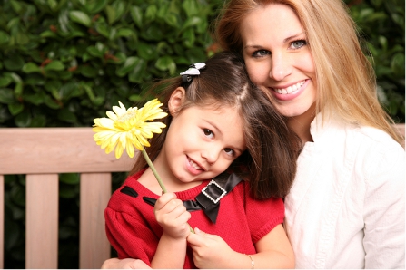 Invisalign special in Carmichael, CA - mom and daughter demonstrating mom with clear invisible aligners to straighten teeth
